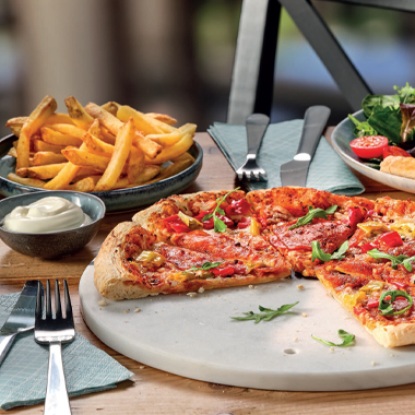 Pzza and chips on a table 